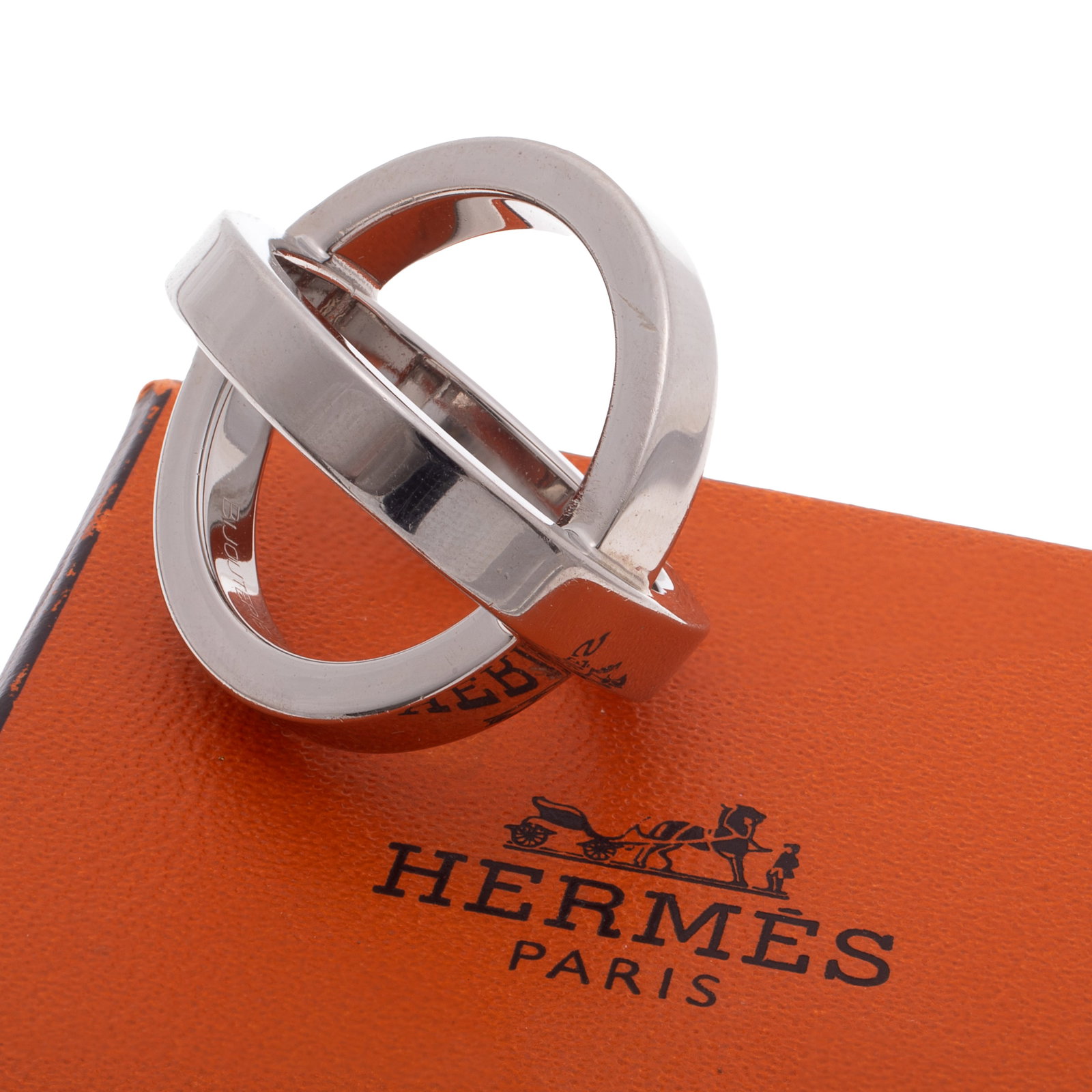 Hermes Cosmos Scarf Ring: Hermes Cosmos Scarf Ring The palladium plated scarf ring measuring approximately 1.04 x 1.00 inches, engraved: Hermes, Bijouterie Fantaisie. Gross weight: 12.0 grams. Accompanied by Hermes box fitted