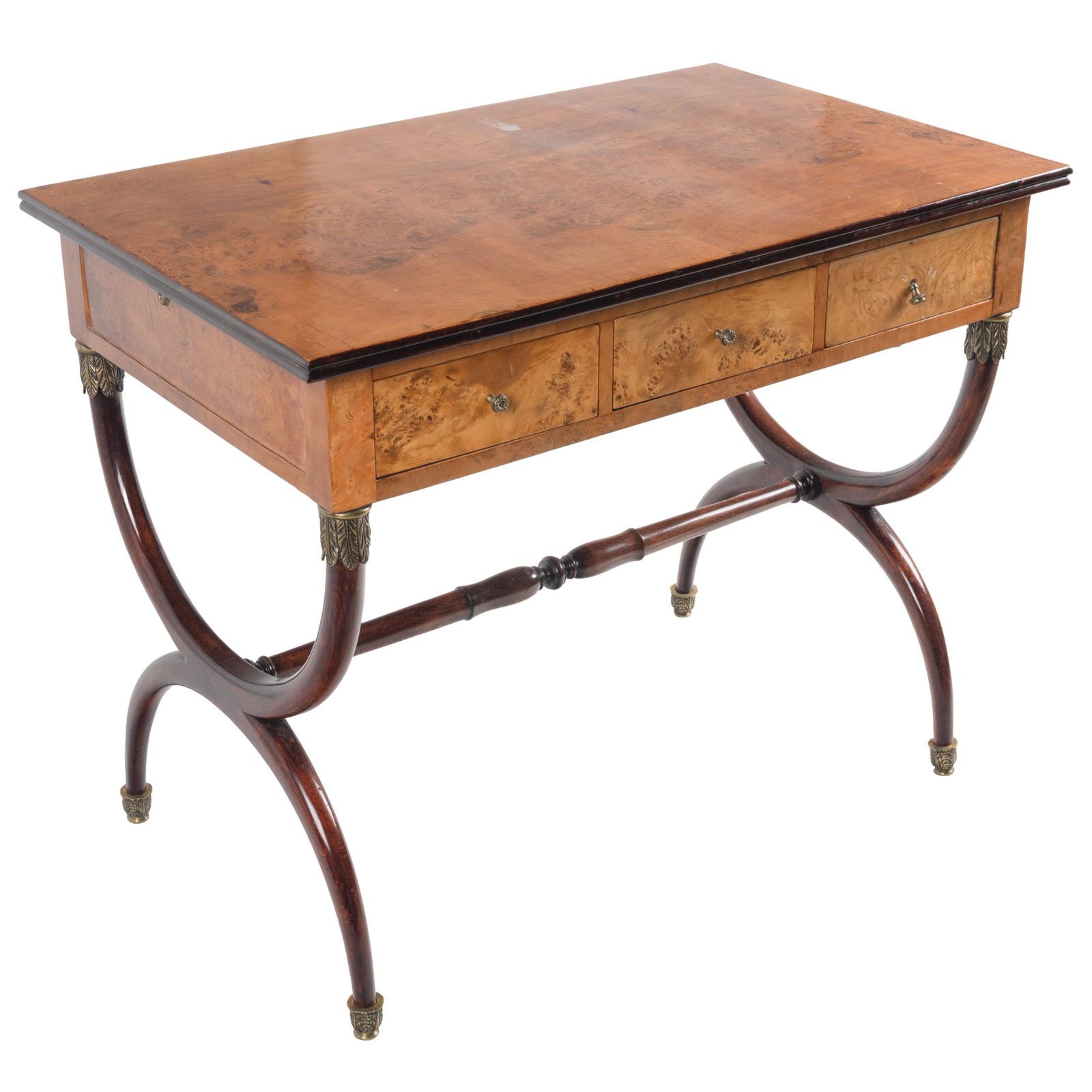 Regency Desk: Regency Desk Circa 1800. The rectangular top of burled walnut above three frieze drawers on double ark supports with gilt palm cuffs. 30in (76cm) h. 39in (99cm) l. 24in (62cm) d. Condition: Slight