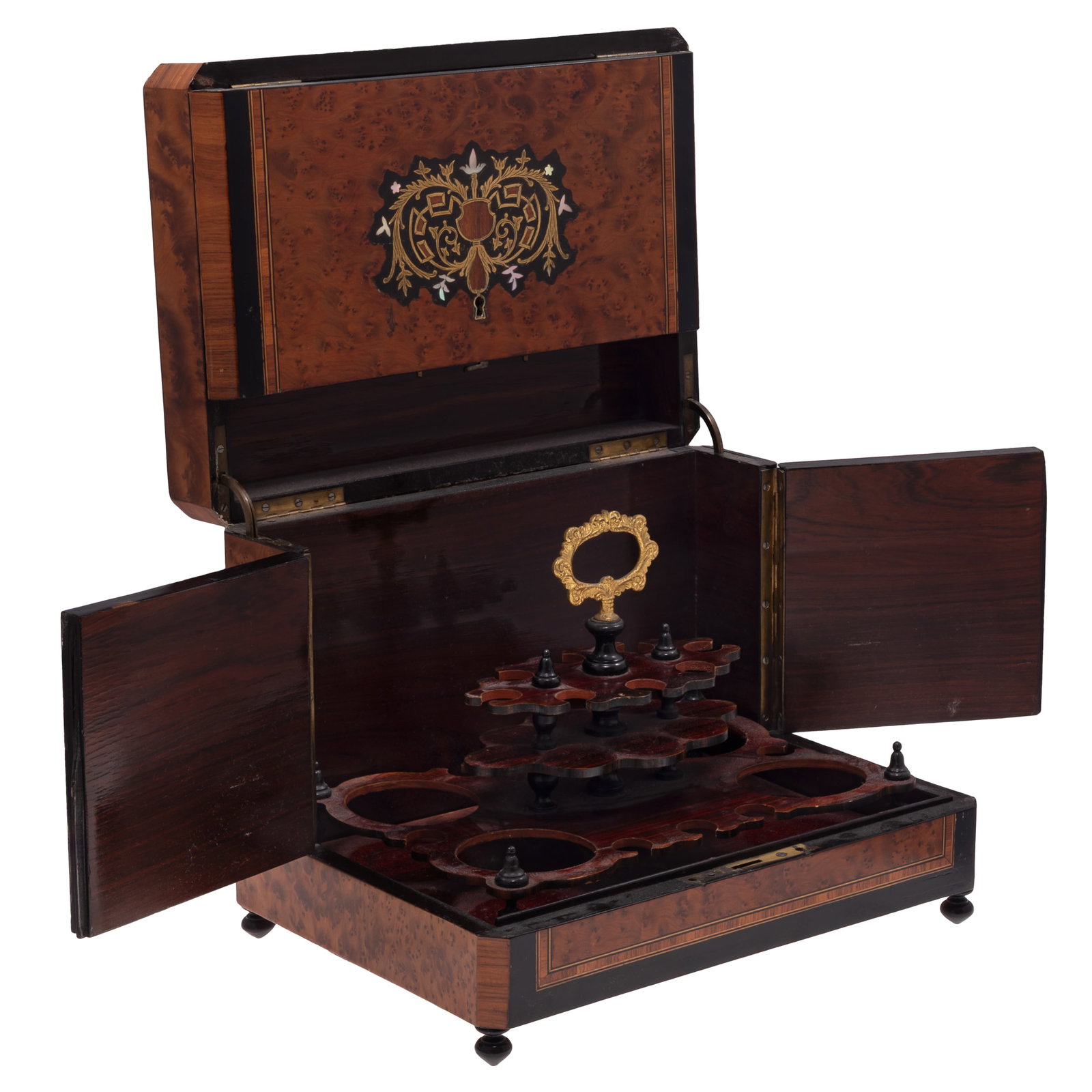 Napoleon III Tantalus: Napoleon III Tantalus The burlwood case inlaid with ebonized and cross banded lines centering a gilt and mother-of-peal heraldic of scrolling acanthus and geometric foliate vines, opening to a case