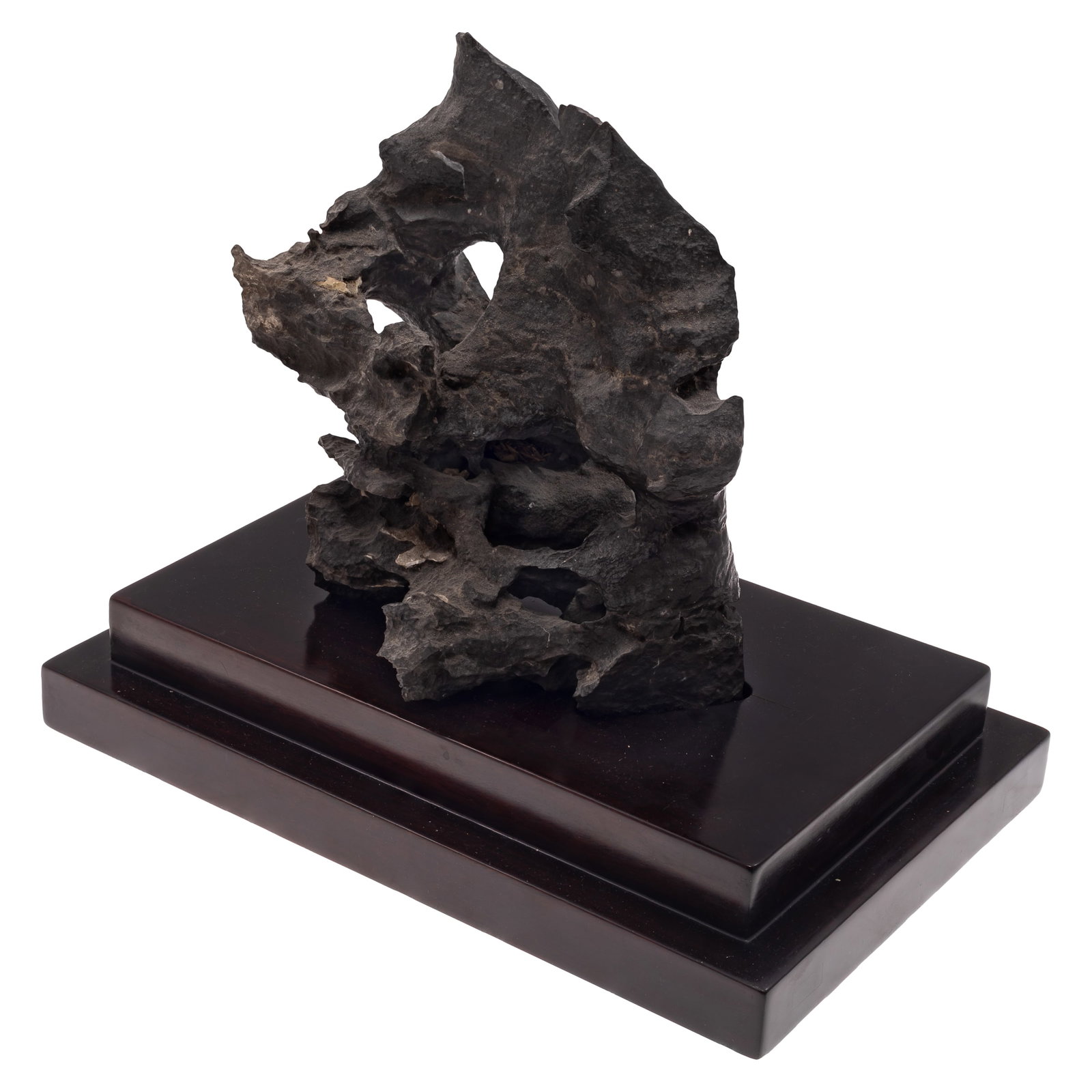 Chinese Scholar's Rock Linbi Stone: Chinese Scholar's Rock Linbi Stone A naturally formed Chinese scholar's rock of pierced and irregular form, displaying dramatic contours and weathered surfaces, mounted on a rectangular stepped black