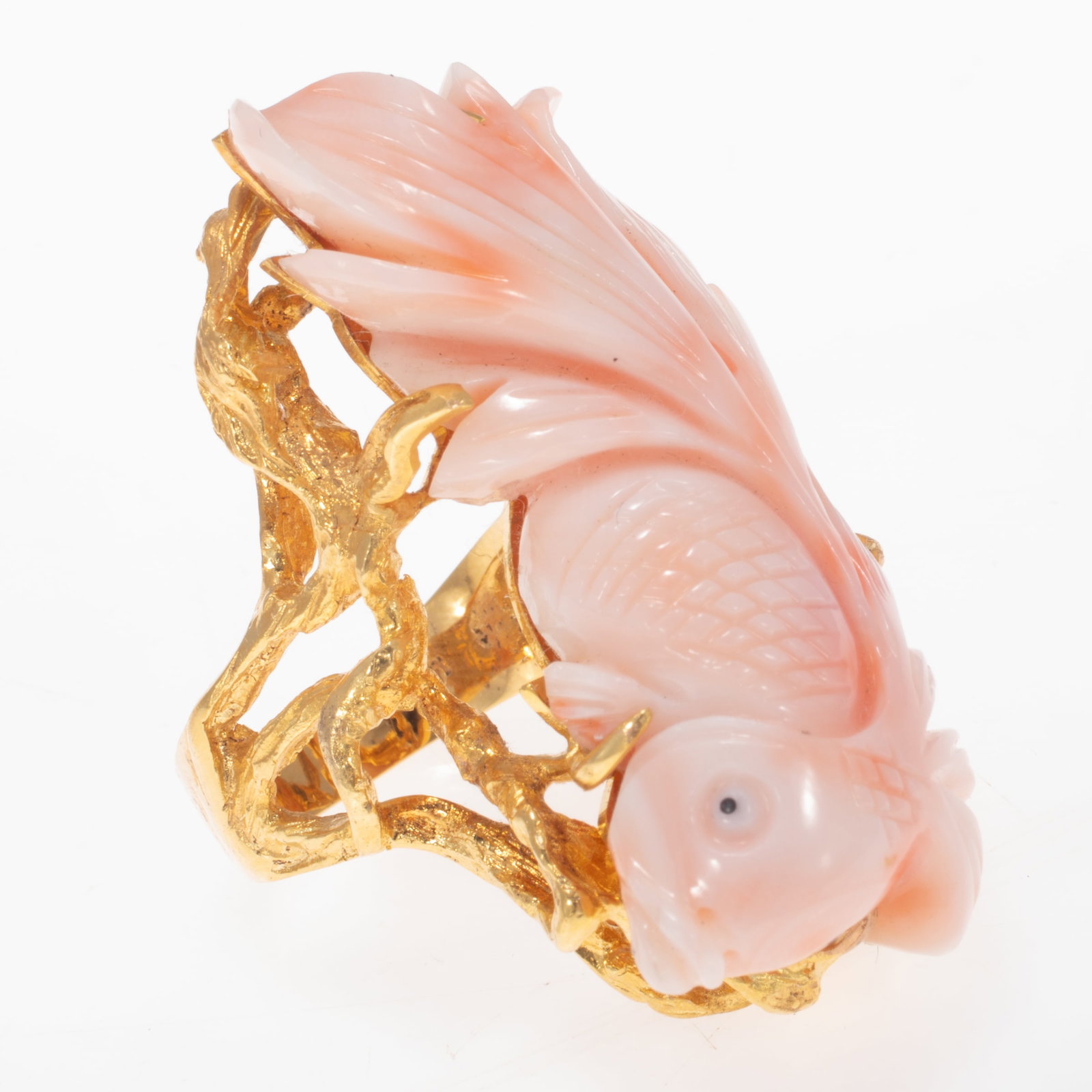Carved Coral, 14k Yellow Gold Ring: Carved Coral, 14k Yellow Gold Ring Featuring coral carved as a swimming fish measuring approximately 42.0 x 19.0 mm, set in an organic 'seaweed' 14k yellow gold ring mounting, size 7. Gross weight: 23