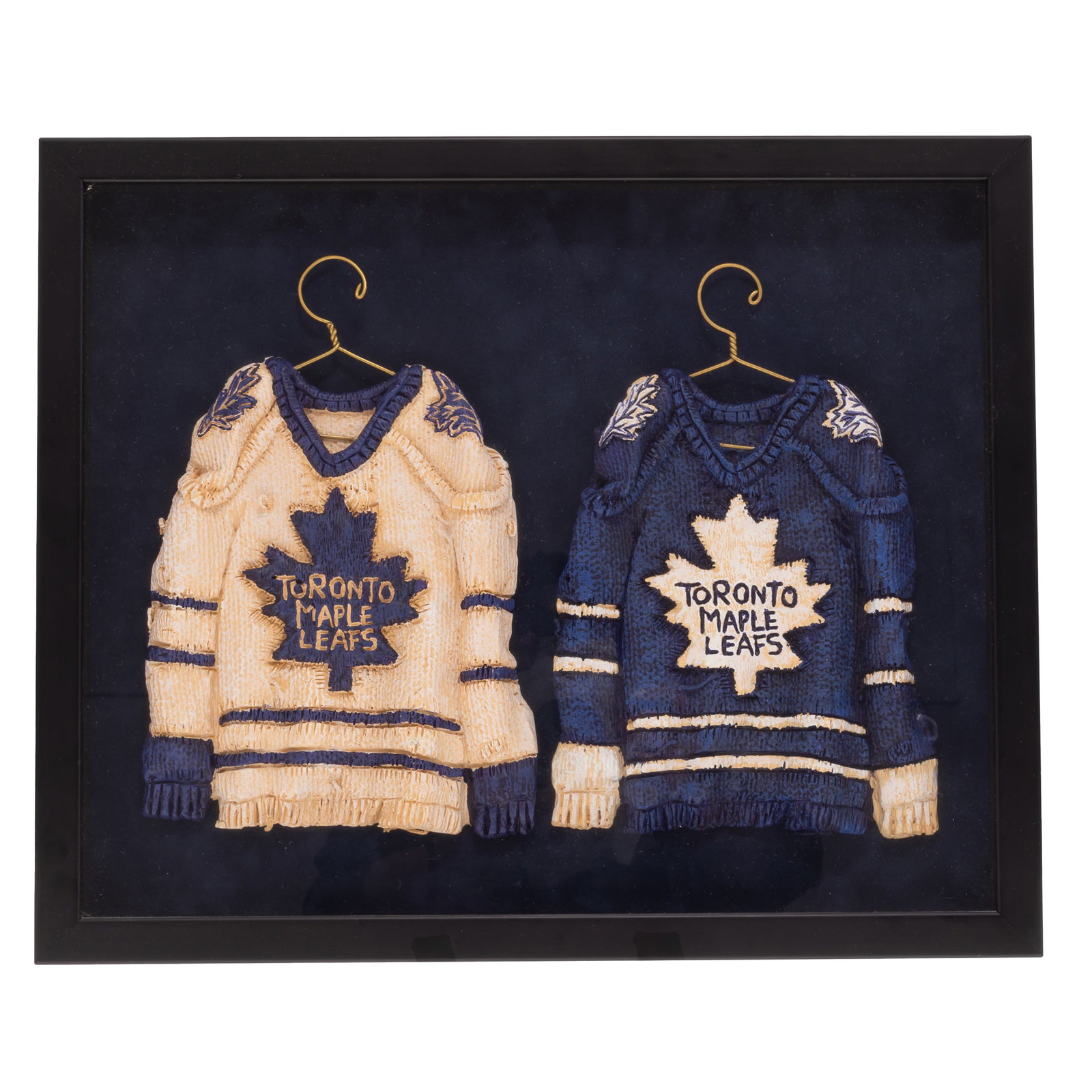 Patrick Amiot (Canadian, b. 1960).: Patrick Amiot (Canadian, b. 1960). Toronto Maple Leaves Sculpture. Hand-painted cast mixed media depicting two Toronto Maple Leaf jerseys. 10 x 7in. each (26 x 18cm). 14 x 17in. (36 x 43cm/framed).