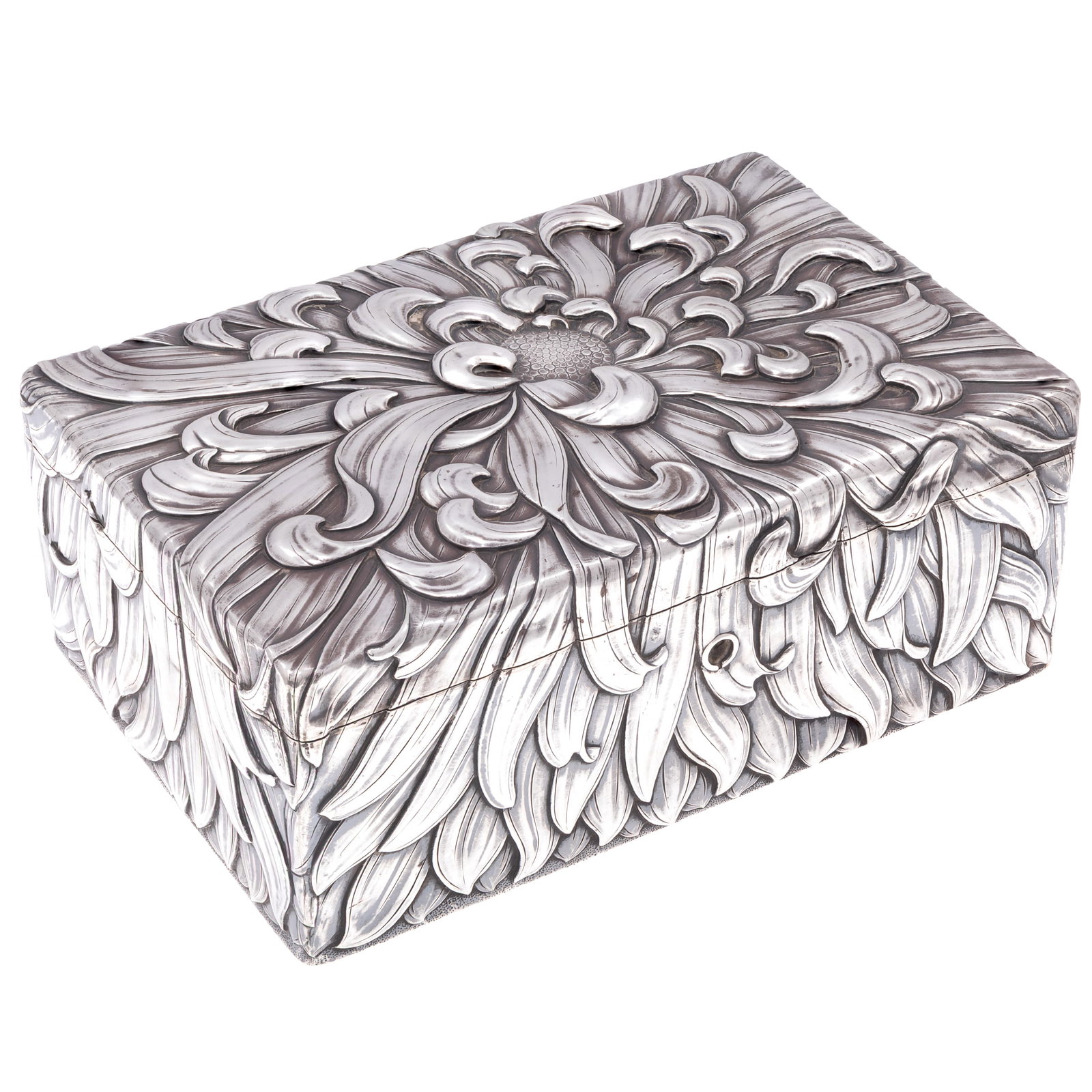 Meiji Silver Jewel Box: Meiji Silver Jewel Box Of dramatic repousse chrysanthemum blossoms opening to a velvet lining. Possible Nomura mark on base 3 1/2in (9cm) h. 9 1/2in (24cm) l. 6in (15cm) d Condition: lacks key