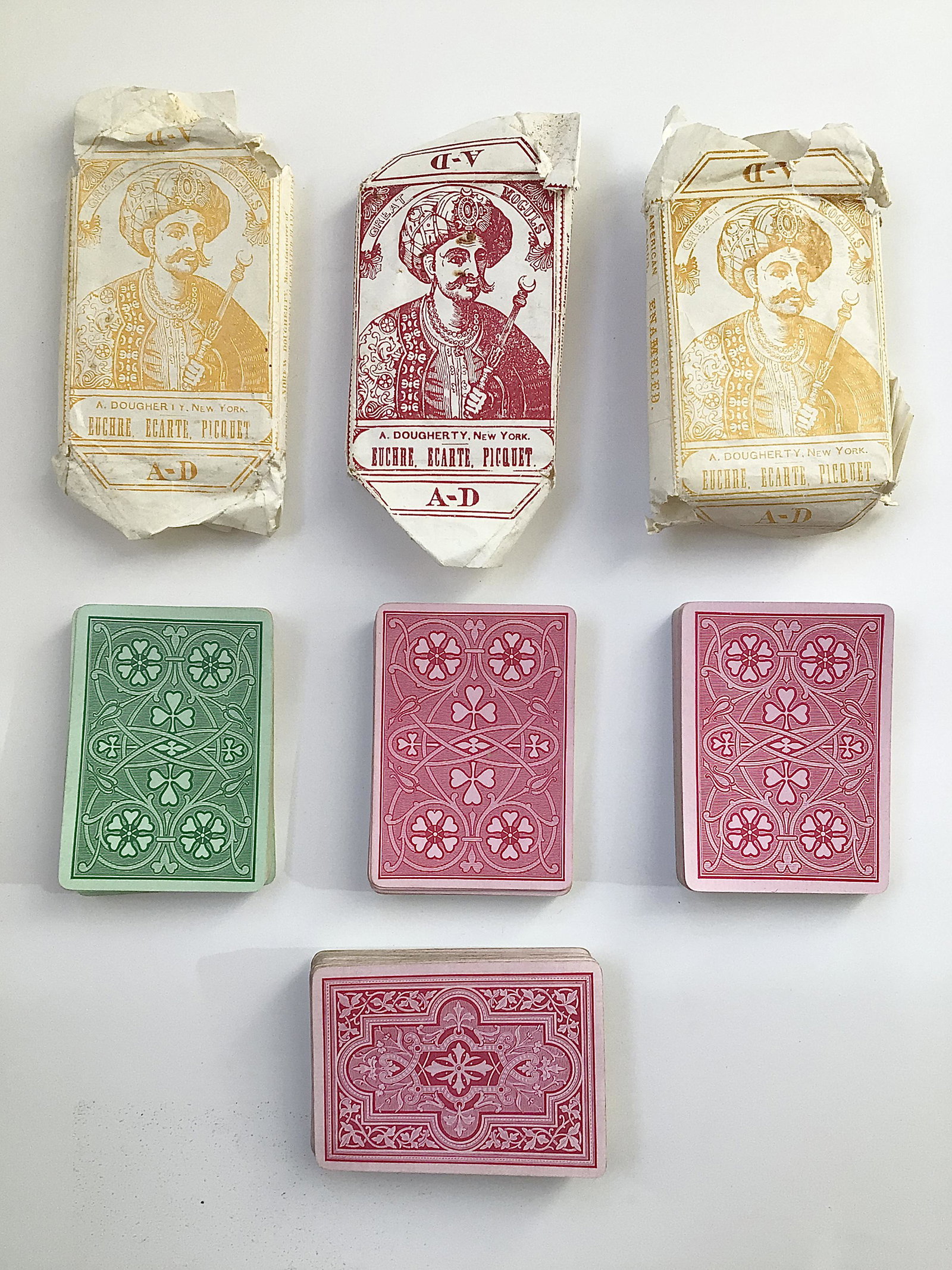 4 Decks of 1870s Playing Cards by A. Dougherty: 4 Decks of 1870s Playing Cards by A. Dougherty. In fair condition with 3 decks having original wrappers. The decks are a bit warped and need to be flattened out. Some decks used more than others. Andr