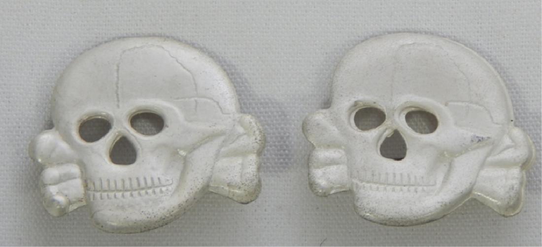 2 German WWll Skull and Cross Bones Medals: Reissue. Measures 1 1/4" x 1 1/4".