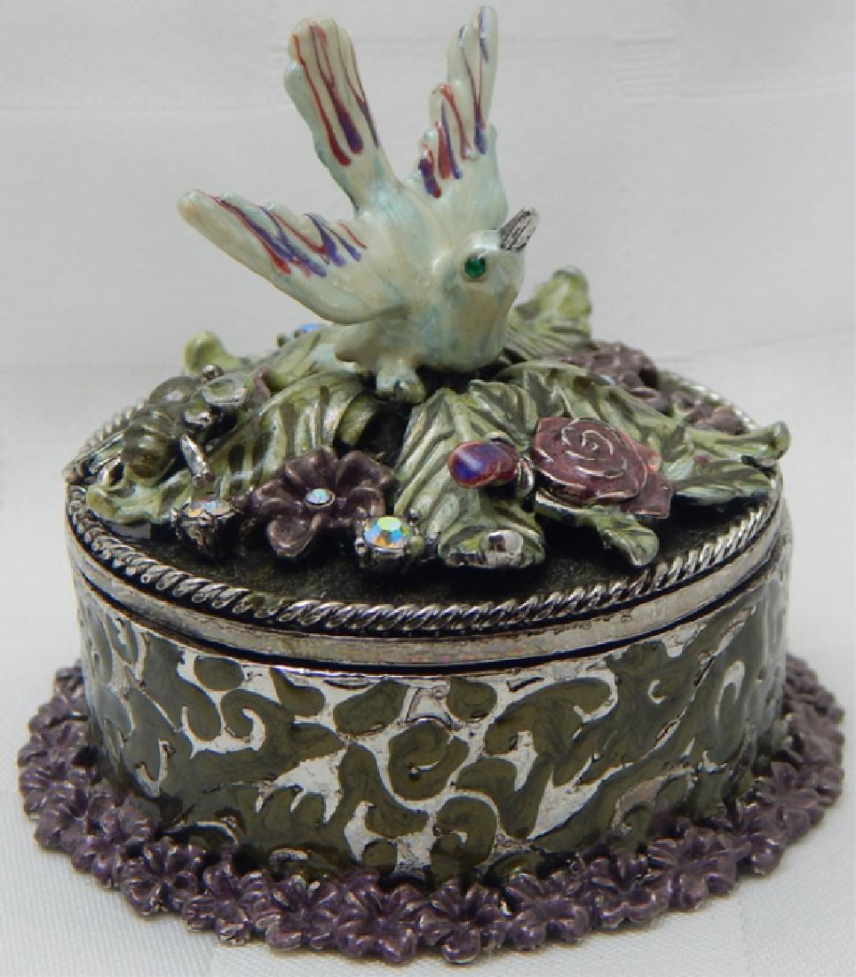 Jeweled Enamel Trinket Box: Bird with flowers decorated with crystals, orange interior and magnetic closure. Measures 2 1/2".