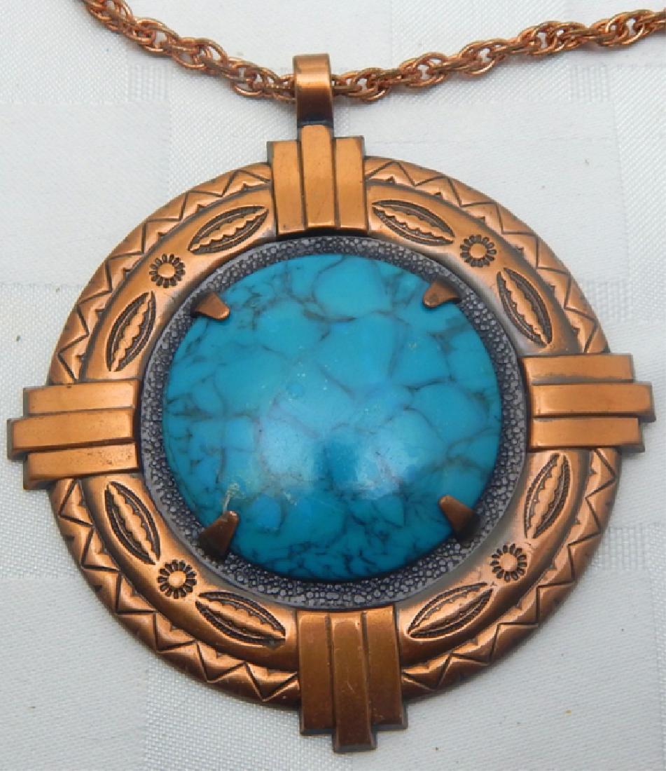 Large Arts & Crafts Copper & Turquoise Necklace: Native American motif on copper pendant with turquoise stone and copper chain. Artist signed with Foundry. Measures 14 1/2".