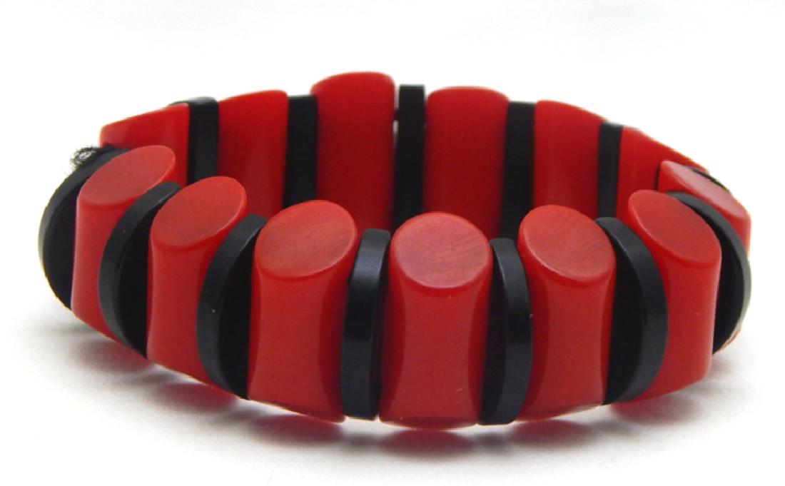 Rare Red and Black Bakelite Bangle, c1930s: Beautiful red and black beaded Bakelite on elastic. Measures 2 3/4" closed. Bakelite was tested. Estimate $200 - $250 Starting Bid $50