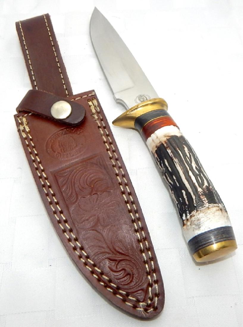 Chipaway Cutlery Hunting Knife with Leather Sheath: Stainless steel blade, faux bone handle with brass finger guard and end, tooled leather double stitched sheath with belt loop. Measures 11" x 3" in sheath. Estimate $40 - $50 Starting Bid $20
