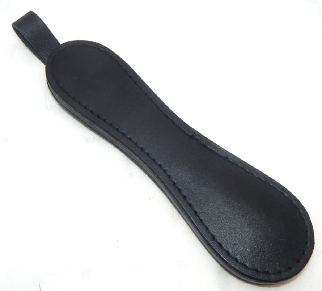 Police Leather Paper Weight: Made of leather and lead with strap. Resembles a blackjack. Measures 9" x 2 3/4". Estimate $20 - $30 Starting Bid $10