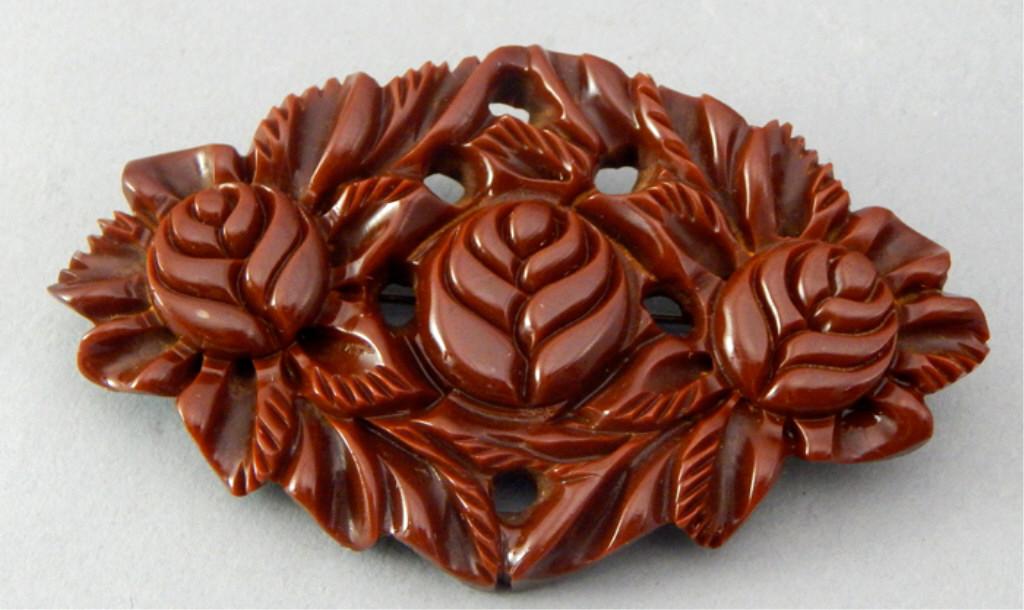 Vintage Carved Brown Bakelite Brooch: Measures 2" x 3". Estimate $30 - $60 Starting Bid $20
