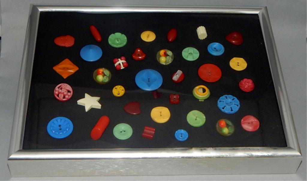 Framed Collection of Antique Buttons, c1930 - 1940: Various old buttons made of Bakelite, wood, etc. in shadow box frame. Measures 12 1/2" x 9 1/2". Estimate $50 - $100 Starting Bid $10