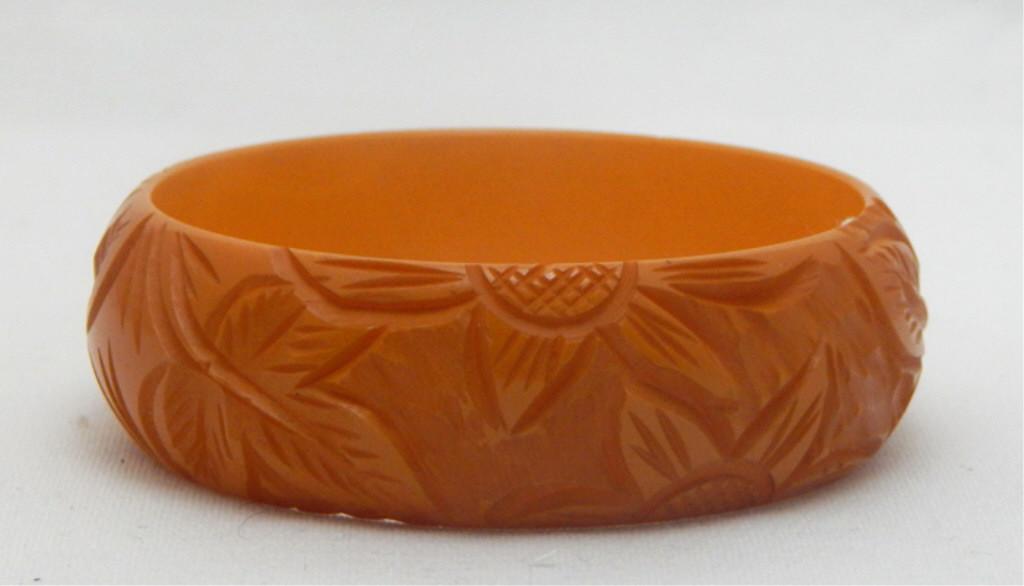 Vintage Carved Butterscotch Bakelite Bangle: Hawaiian flowers. Estimate $200 - $300 Starting Bid $20