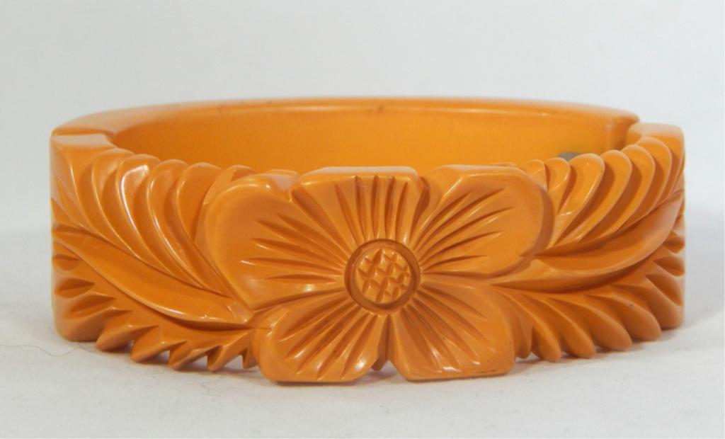 Vintage Carved Butterscotch Bakelite Hinged Bangle: Hawaiian flower. Estimate $200 - $300 Starting Bid $20
