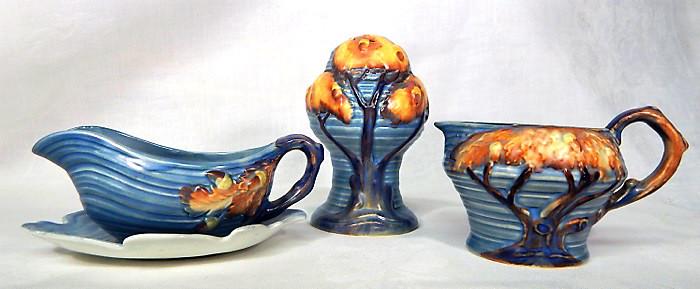 Carlton Ware "Night Oak" Pottery, 3 pieces: Blue Night Oak Tree pattern large shaker 5" x 3", condiment with handle and under plate 2" x 5 1/2", and cream 2 1/2" x 4". Made in England, c1930s. Makers mark and incised number. Estimate $100 - $15
