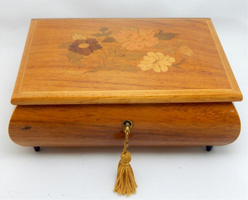 Gueissaz Jaccard Swiss Marquetry Inlaid Music Box: Inlaid flowers on lid, piano hinge, red velvet lining and key. Swiss movement plays Die Kleine Nachtmusik (Mozart). Good working condition. Measures 3" x 7" x 5". Estimate $50 - $150 Starting Bid $20