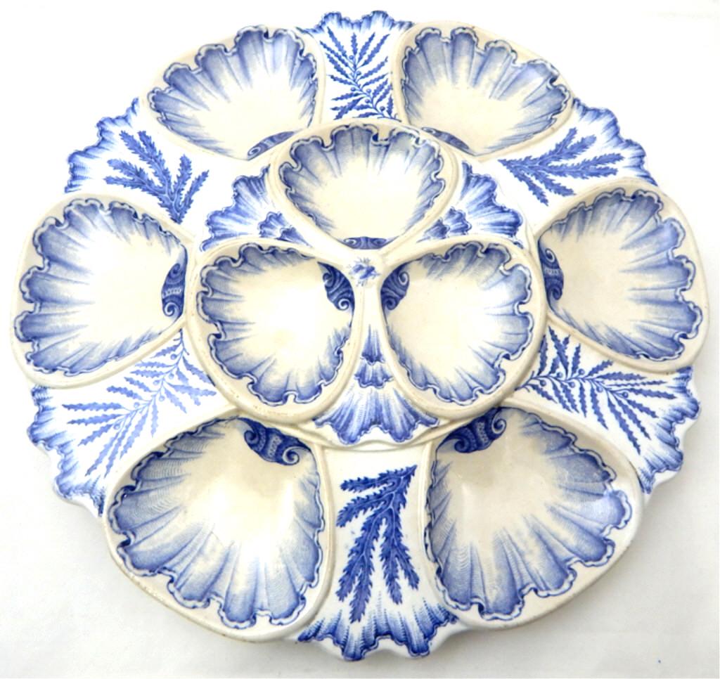 Hand Painted Flo Blue Footed Oyster Platter, c1900: Hand painted designs in blue with six oyster wells and three sauce wells, has incised markings and six ball feet. Measures 10". Good condition. Estimate $400 - $600 Starting Bid $30