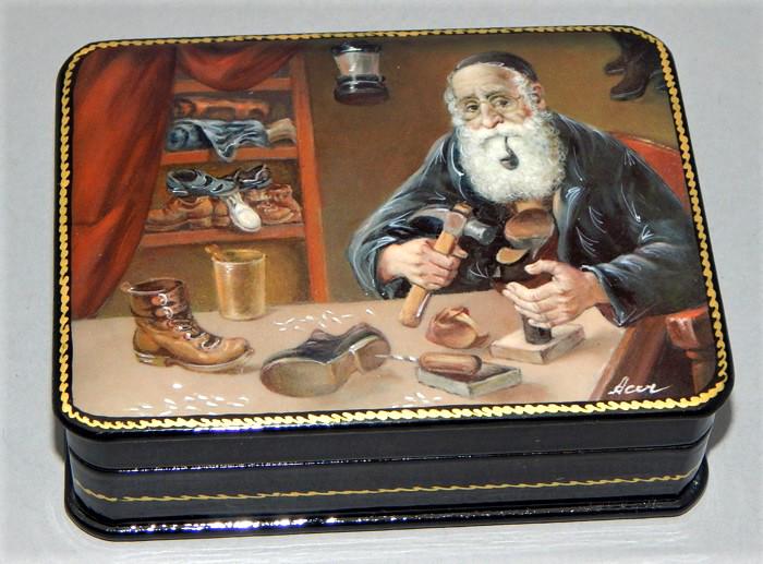 Vintage Russian Lacquer Box: Hand painted Jewish Rabbi Cobbler holding tool and smoking a pipe with shoes on the table, very detailed and artist signed. Great condition. Measures 4" x 3". Estimate $100 - $300 Starting Bid $20