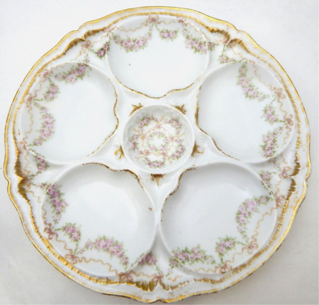 Theodore Haviland Limoges Oyster Plate, c1890: Hand painted with tiny flowers, ribbons and bows, and gold accents and trim, has five oyster wells and one sauce well. Marked "Theodore Haviland Limoges France Patent Applied For". Good condition. Mea