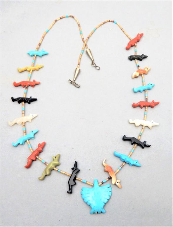 Stone, Heishi Shell & Sterling Fetish Necklace: Native American handmade Fetish necklace with Mother of Pearl, Turquoise, Coral, Jade, Onyx and abalone foxes, Heishi shell beads, turquoise eagle pendant and sterling horns. Measures 13". Estimate $4