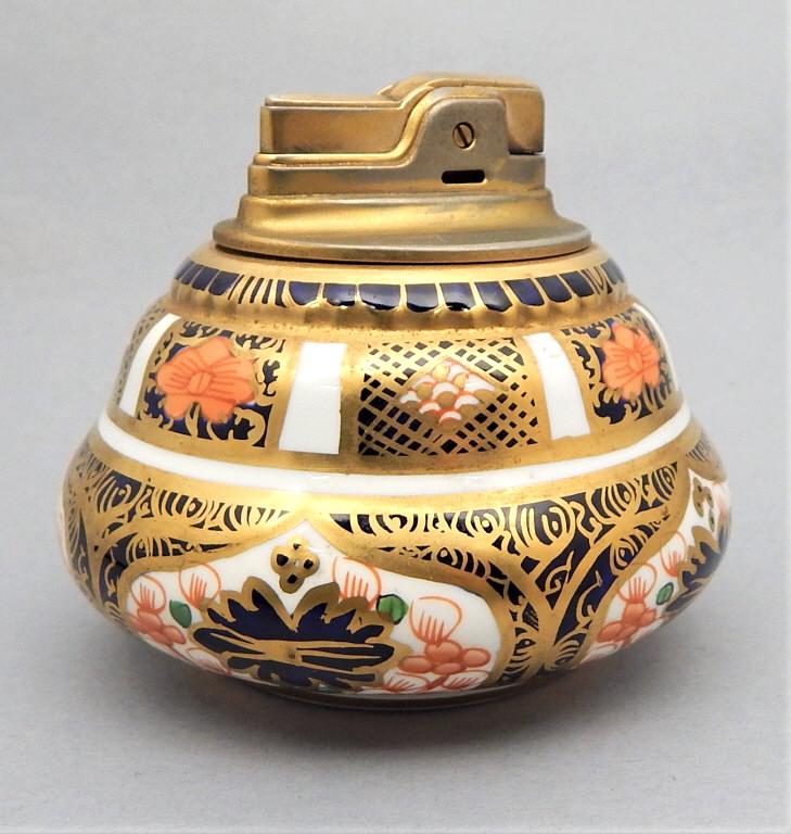 Royal Crown Derby Imari Ronson Table Lighter: Royal Crown Derby porcelain, Imari pattern, Ronson lighter, has makers marks along with "Fashioned Exclusively for Ronson". Measures 3" x 3 1/2". Estimate $40 - $80 Starting Bid $10