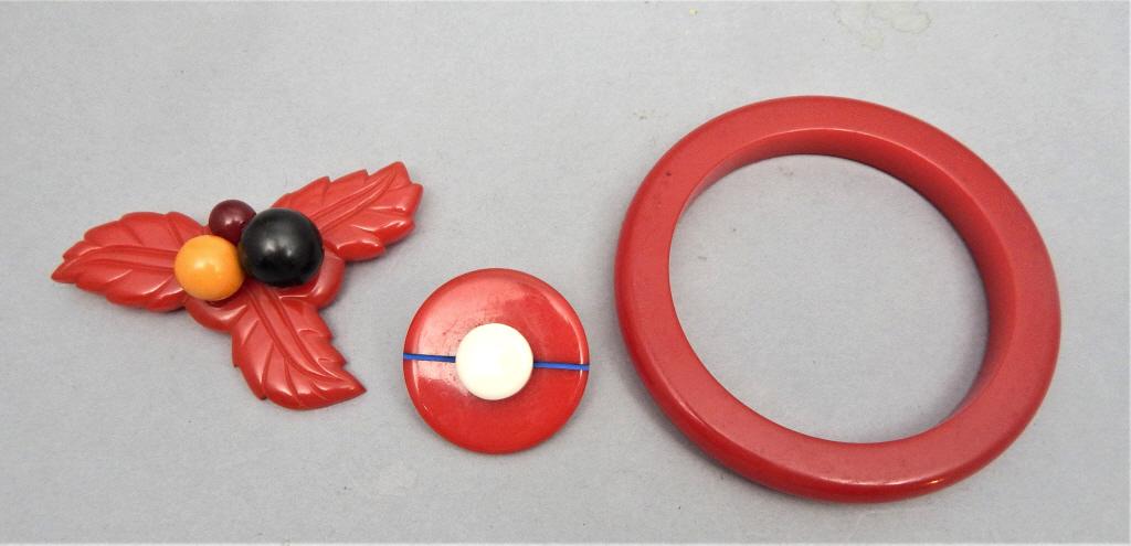 Vintage Bakelite Bangle & Brooches: Total of three pieces. Estimate $50 - $100 Starting Bid $10
