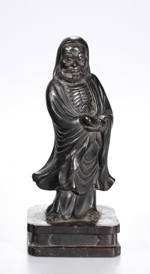 A Damo figure hardwood carved in draped robe, Chinese: A Damo figure hardwood carved in draped robes. Very finely carved heavy hardwood (zitan?), Chinese early 20th C. or earlier Height: 28,3 cm / 11,10 in
