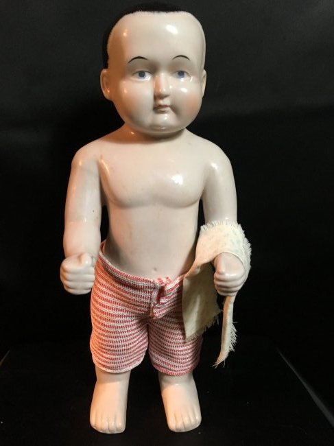 Antique/Vintage Unmarked Frozen Charlie: 12 1/2" antique/vintage frozen Charlie. No markings. Muted cheek color, paint eyes, painted black hair. No damages to porcelain. Comes with vintage shorts and hand towel. Ships from Canada.