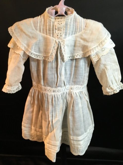Antique Doll Dress: Sweet antique dress with insertion lace at the waist. Minor imperfections, nice condition. It measures 16 1/2" long. 8" across waist. Sleeves are 7" long. Ships from Canada.