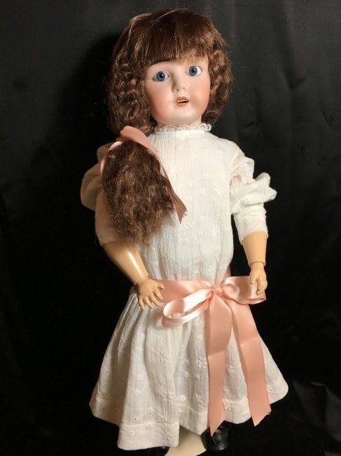 French Limoges Antique Bisque Head Doll: 20" lovely antique French bisque head doll. No damages to bisque head incised LIMOGES/FRANCE/8. Blue set eyes, open mouth with teeth. Vintage Global wig. Jointed composition body has had a repaint, le