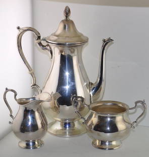 Cartier Sterling Silver Roxbury Coffee Set: Cartier sterling silver coffee set consisting of 3 pieces in the Roxbury Pattern . The coffee pot being approx. 9 3/4 tall. Approx. 21 Troy ounces Signed Cartier sterling 9465 Roxbury.