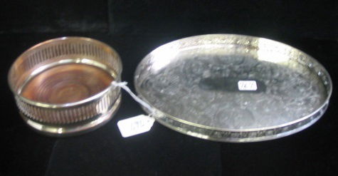 TWO BRITISH SHEFFIELD PLATED TABLE ACCESSORIES. O: TWO BRITISH SHEFFIELD PLATED TABLE ACCESSORIES. One is a wine coaster, silver on copper, with hardwood base, marked Sheffield with trademark on rim, pierced sides, 5-1/4 in. diameter; together with a