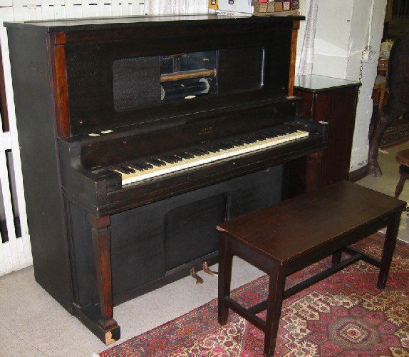 MAHOGANY UPRIGHT PLAYER PIANO WITH BENCH AND PLAYER: MAHOGANY UPRIGHT PLAYER PIANO WITH BENCH AND PLAYER ROLLS, the Aeolian Co., New York, serial #38292, c. 1914. Cabinet dimensions: 55"H x 58.75"W x 28.5"D. Lot includes 24 player rolls.