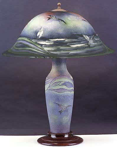PAIRPOINT SIGNED TABLE LAMP in seagull pattern.: PAIRPOINT SIGNED TABLE LAMP in seagull pattern. The blue-gray field Copeley-shaped glass shade reverse hand painted with gulls in flight. The shade also signed by Fisher (Hugo Melville Fisher) 1876-19