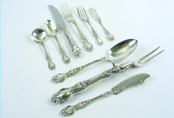 A WALLACE LILY STERLING SILVER FLATWARE SET, by Wa: A WALLACE LILY STERLING SILVER FLATWARE SET, by Wallace Silversmiths, American, 86 pieces, 1904. The set is service for 12, comprising 12 dinner knives, 12 dinner forks, 16 salad forks, 12 teaspoons,