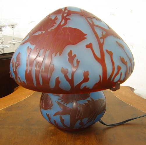 AN ART GLASS CAMEO STYLE LAMP, signed "Charder". T: AN ART GLASS CAMEO STYLE LAMP, signed "Charder". The dome shade and base in a swimming fish design with seaweed accents, brown on blue ground, 11 in. ht.
