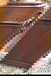 REGINAPHONE MUSIC BOX ON CABINET FLOOR STAND WITH: REGINAPHONE MUSIC BOX ON CABINET FLOOR STAND WITH DISCS, the Regina Music Box Co., Rahway, N.J., serial #1390126, c. 1900. The mahogany cased music box has a vented lift top, the spring wound action p