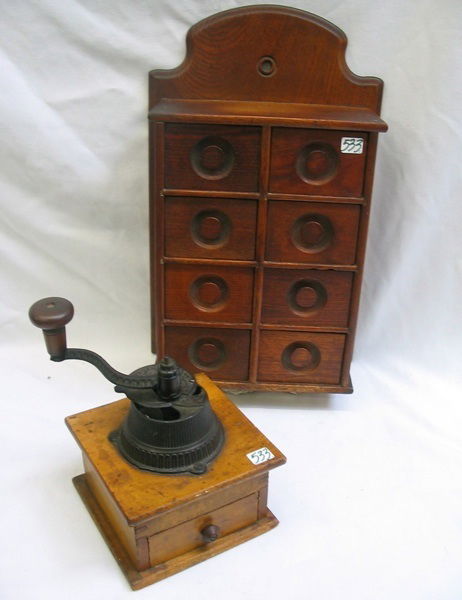 TWO EARLY AMERICAN WOOD KITCHEN ITEMS. One is a w: TWO EARLY AMERICAN WOOD KITCHEN ITEMS. One is a wall hanging spice box of 8 drawers, 17-1/2 in. ht.; the other a 19th C. hand crank coffee grinder, with small drawer below, iron mounts. Height 8-1/2 i
