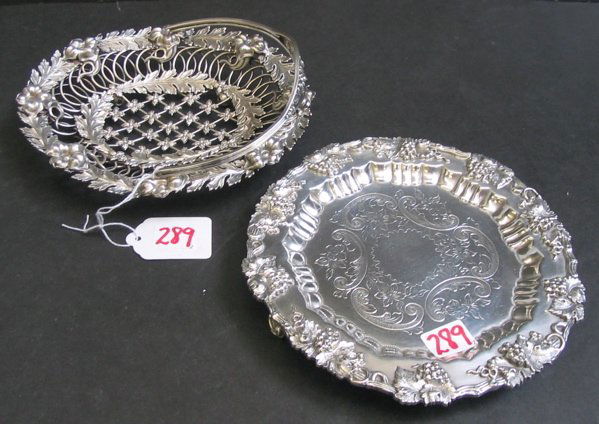 TWO SILVER PLATED TABLE ACCESSORIES. One is a Sh: TWO SILVER PLATED TABLE ACCESSORIES. One is a Sheffield wine coaster, vintage grape and vine band with engraved center, with handle, 6-1/2 in. dia.; together with a filigreed calling card basket, flor