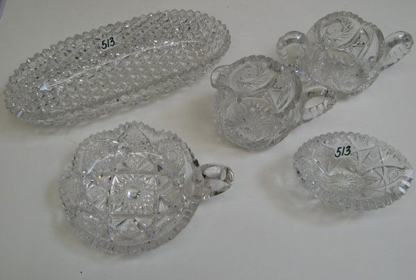 A GROUP OF FIVE AMERICAN CUT CRYSTAL TABLE ACCESS: A GROUP OF FIVE AMERICAN CUT CRYSTAL TABLE ACCESSORIES. Including an ice cream serving bowl in the Russian cut pattern, 11-1/4 in. length; a cream and sugar set, hobstar pattern; a napy and a small ca
