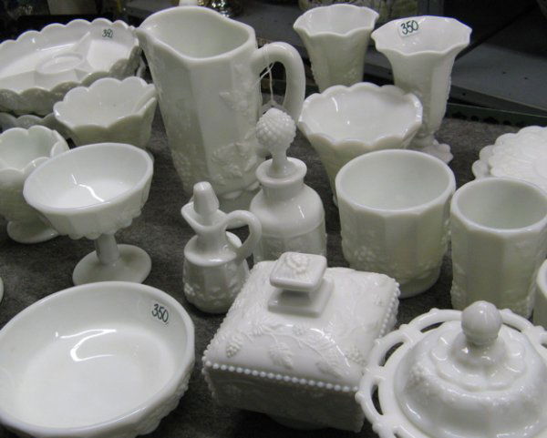 A COLLECTION OF AMERICAN WESTMORELAND GLASS TABLE: A COLLECTION OF AMERICAN WESTMORELAND GLASS TABLE ACCESSORIES, 27 pieces, all-white in the vintage grape pattern. Including 2 flower basket vases, 11-1/4 in. ht., 1 pitcher, 5 candy dishes,4 vases, 2