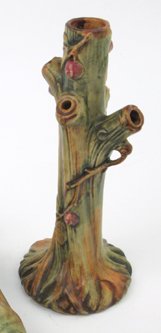 AN AMERICAN WELLER WOODCRAFT POTTERY BUD VASE, a t: AN AMERICAN WELLER WOODCRAFT POTTERY BUD VASE, a tree trunk accented with red berries and leafing branches, 10-1/2 in. ht., early 20th C.