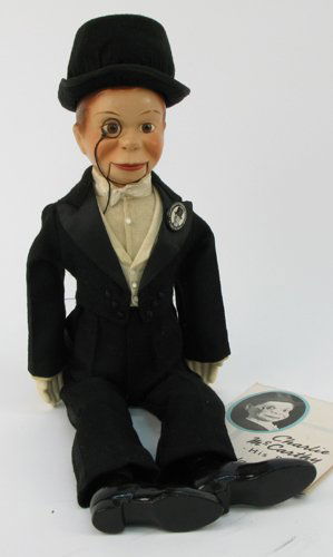 AN EFFANBEE CHARLIE MCCARTHY DOLL, 20 in., in ori: AN EFFANBEE CHARLIE MCCARTHY DOLL, 20 in., in original box, with original clothes, shoes, button and brochure, hard vinyl head, painted features, string pull mouth with black eye glasses. Original box