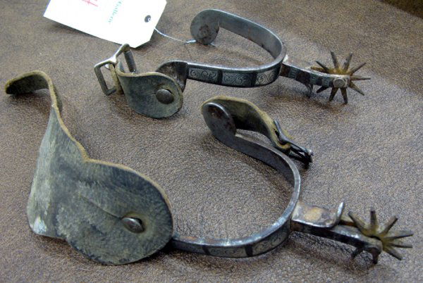 PAIR OF AUGUST BUERMANN SILVER INLAID SPURS, ten po: PAIR OF AUGUST BUERMANN SILVER INLAID SPURS, ten point rowels, six engraved and inlaid silver panels on outside, repeating arch leaf design on inside, shallow-drop shanks with chap guards, marked "HAN