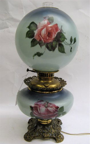 AMERICAN GONE WITH THE WIND TABLE LAMP, the base a: AMERICAN GONE WITH THE WIND TABLE LAMP, the base and globular shade with rose decoration, fitted on an iron gilt metal base, clear glass chimney, 23" H.