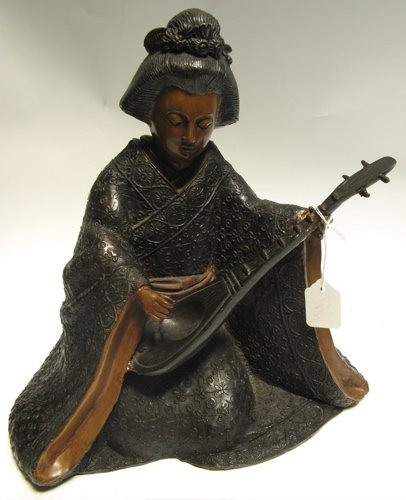 BRONZE FIGURE OF A WOMAN in traditional costume, s