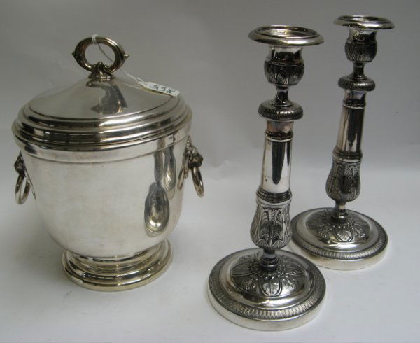 THREE SILVER PLATED TABLE ACCESSORIES, including a: THREE SILVER PLATED TABLE ACCESSORIES, including an insulated covered ice bucket, lion mask handles with rings, 11-1/2" H.; together with a pair of candlesticks, chased and engraved design, 11".