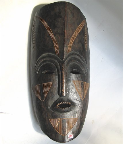 AN AFRICAN HAND CARVED MASK of elongated form, in