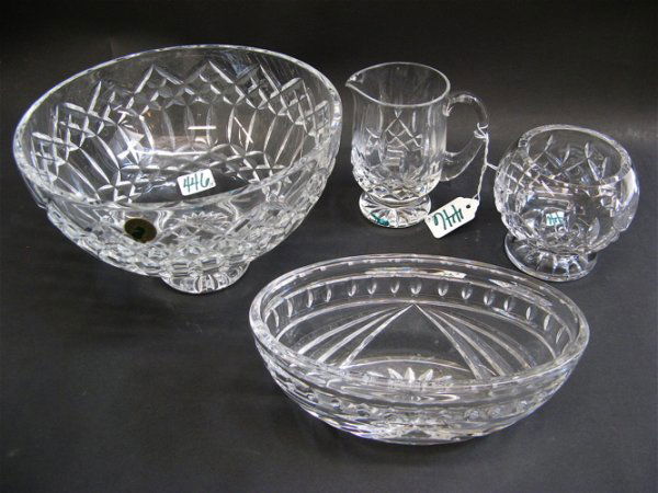 FOUR WATERFORD CUT CRYSTAL TABLE ACCESSORIES, inc: FOUR WATERFORD CUT CRYSTAL TABLE ACCESSORIES, including a footed centerpiece bowl, 8" D. by 5" H., with original paper label; an oval bowl, 7" by 3-3/4"; together with a cream pitcher and footed open