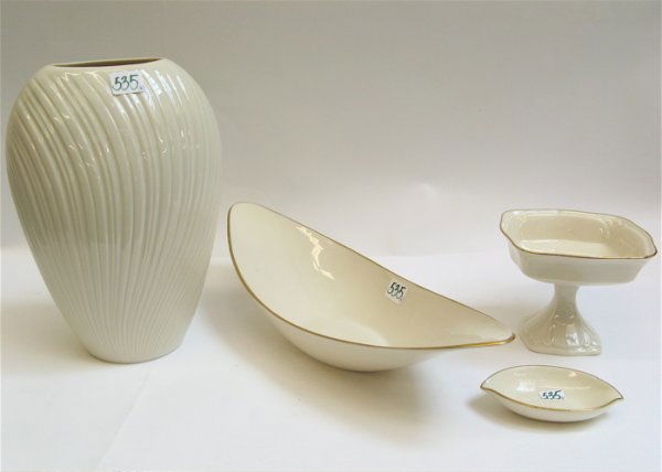 FOUR LENOX PORCELAIN IVORY TABLE ACCESSORIES, inc: FOUR LENOX PORCELAIN IVORY TABLE ACCESSORIES, including a large vase, 10-1/2" H.; a gold banded oval celery dish, 15-1/2" L.; a gold banded square compote, 4-1/4" H.; together with a small gold banded